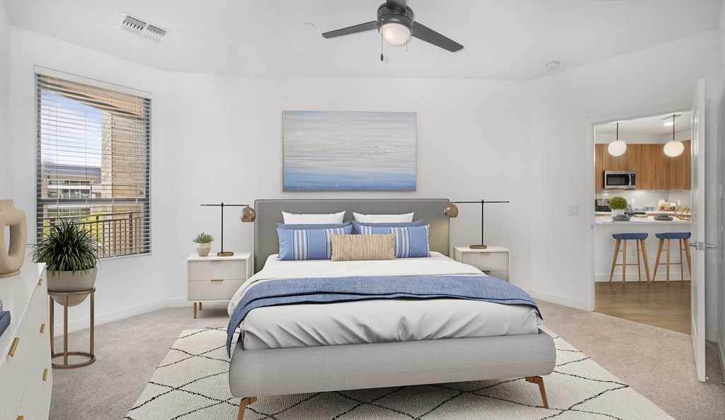 a bedroom with a bed and a ceiling fan