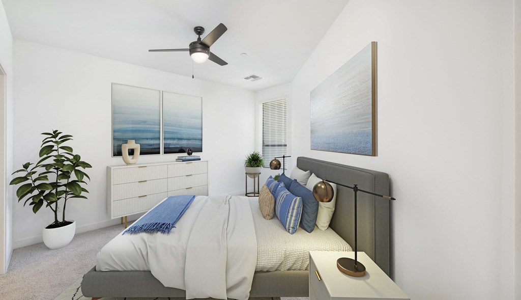 a bedroom with a bed and a ceiling fan