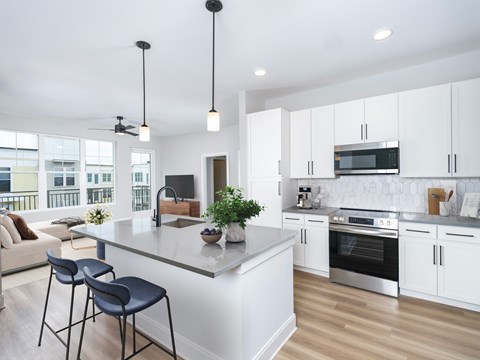 A modern kitchen with white cabinets and a large island.
