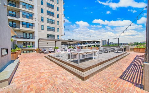 an outdoor patio with tables and chairs at an apartment building