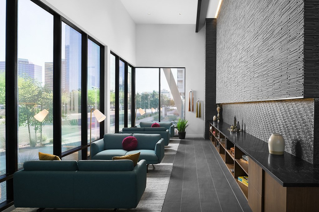 a living room with blue couches and a large window