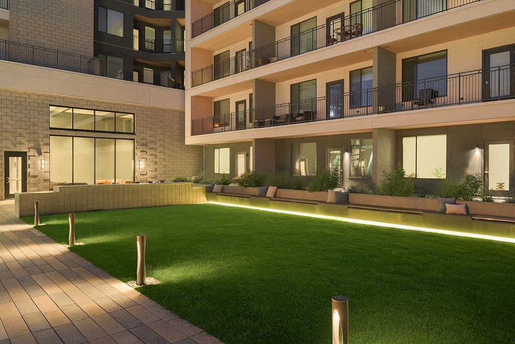 an apartment building with a lawn in front of it