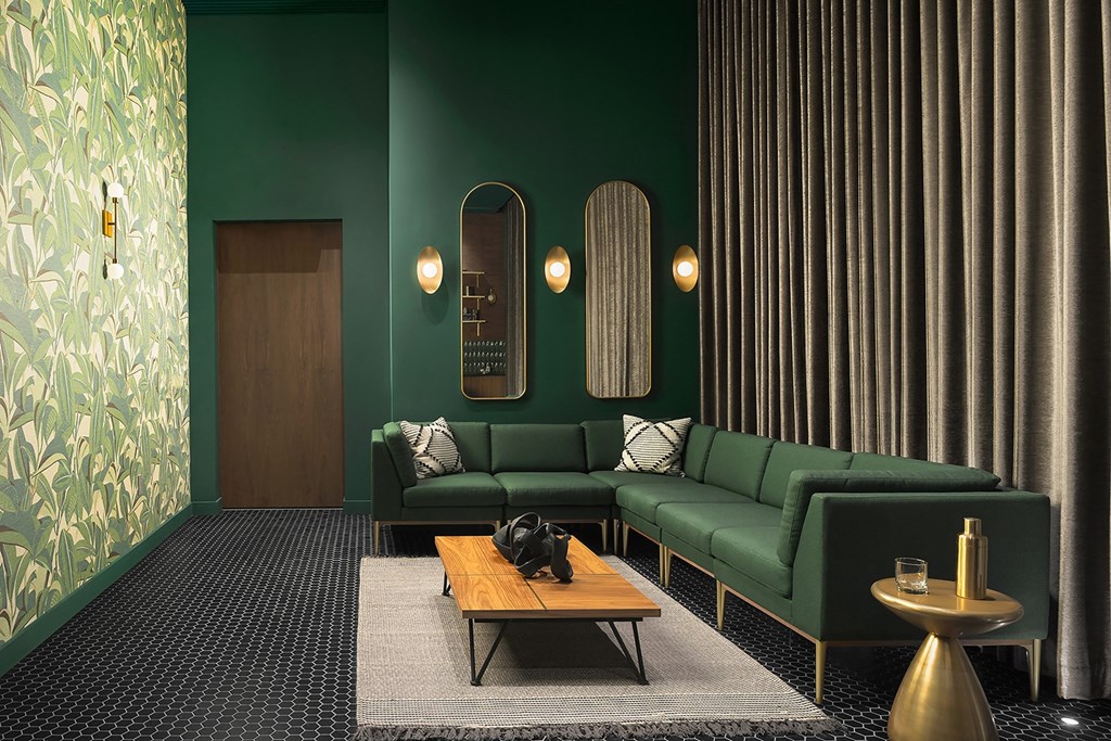a living room with green couches and a coffee table