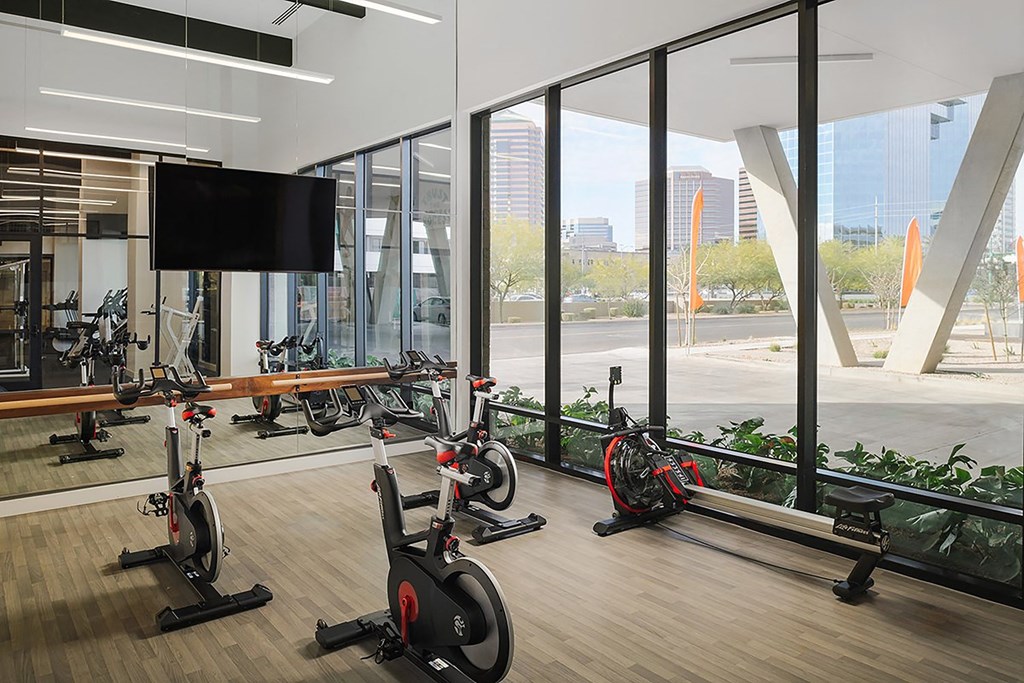 a gym with exercise bikes and a television