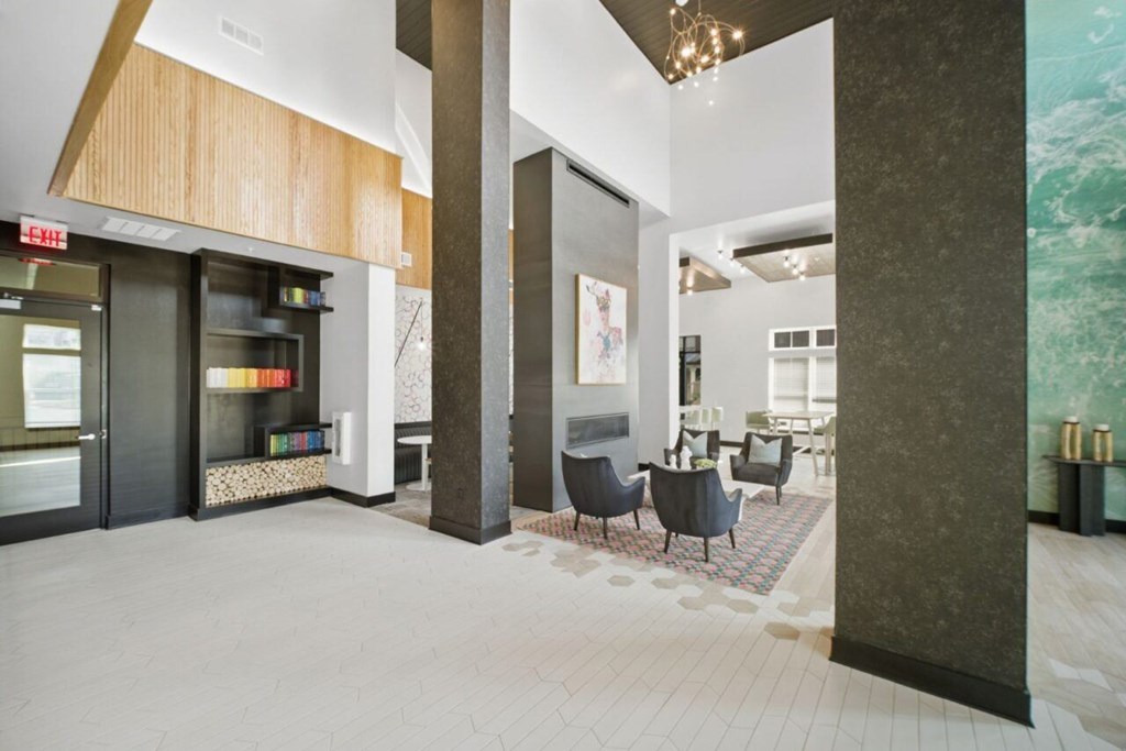 A modern lobby with a wooden ceiling and a large painting on the wall.