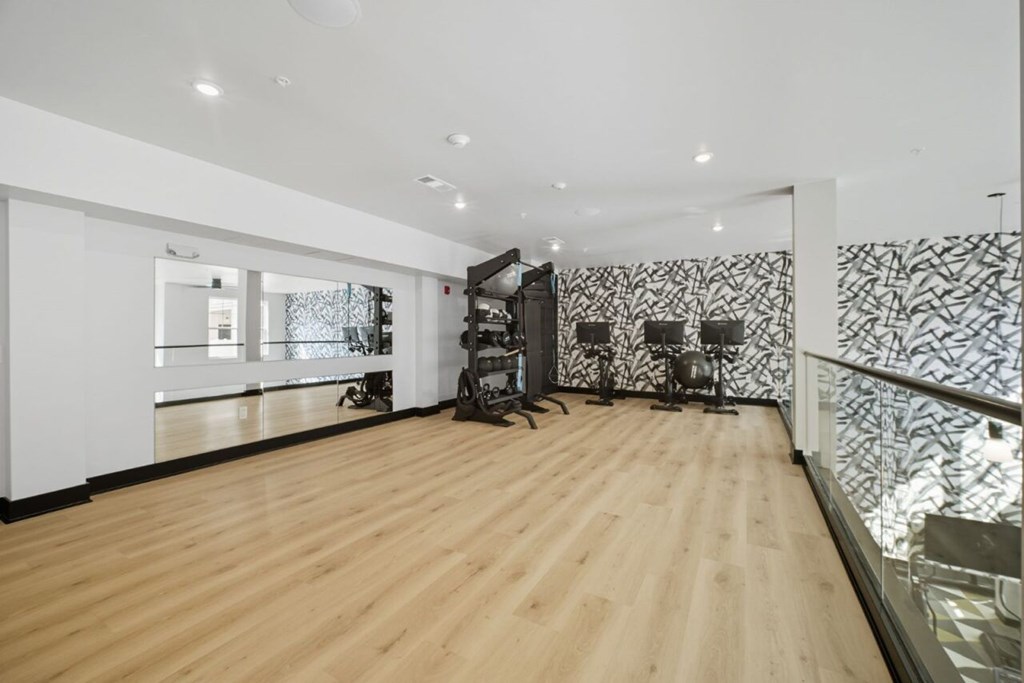 A room with wooden floors and a glass railing.