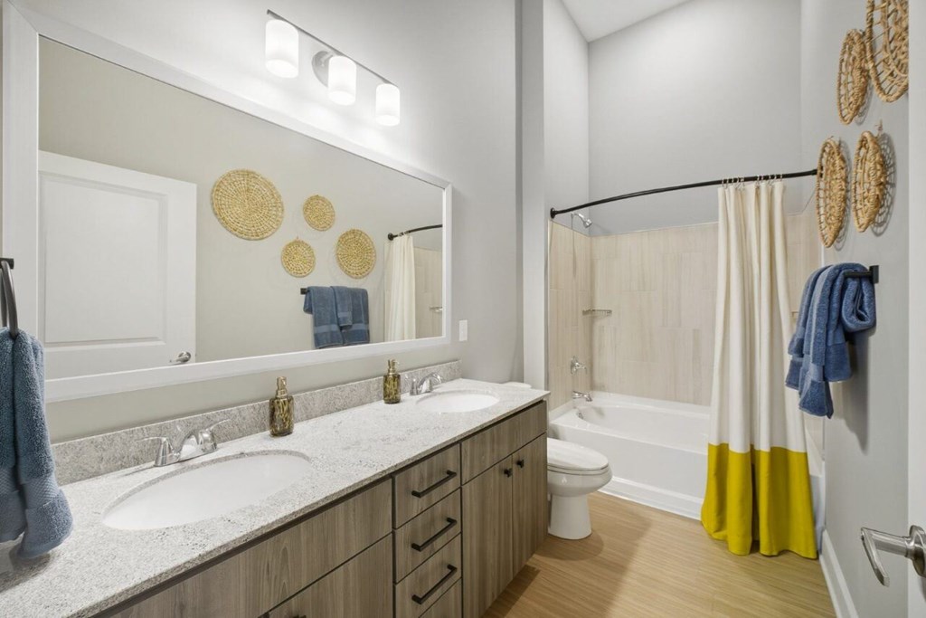 A bathroom with a white sink and a white toilet.
