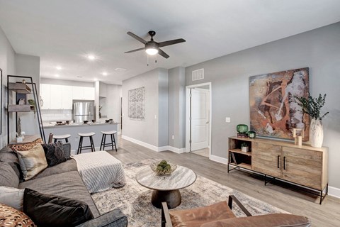 A living room with a grey couch and a brown chair.
