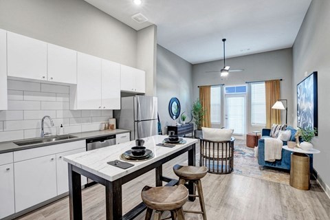 A modern kitchen with a dining table and chairs.