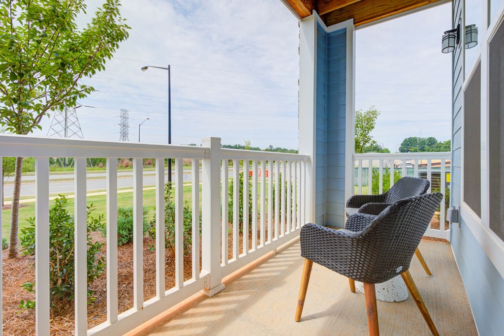 country style patio with two chairs and shrubbery