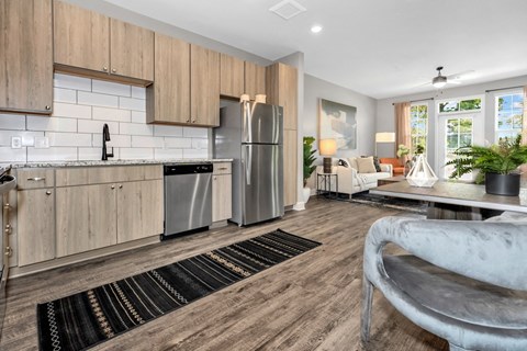 a kitchen with wooden cabinets and a stainless steel refrigerator