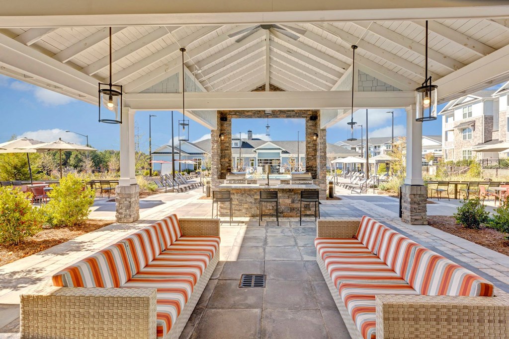 a patio with couches and chairs and tables