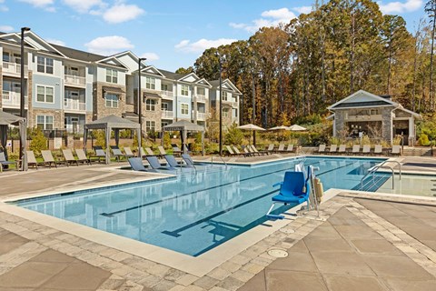 Saltwater swimming pool with sundeck and lounge seating at Argento at Kellswater apartments in Kannapolis, NC