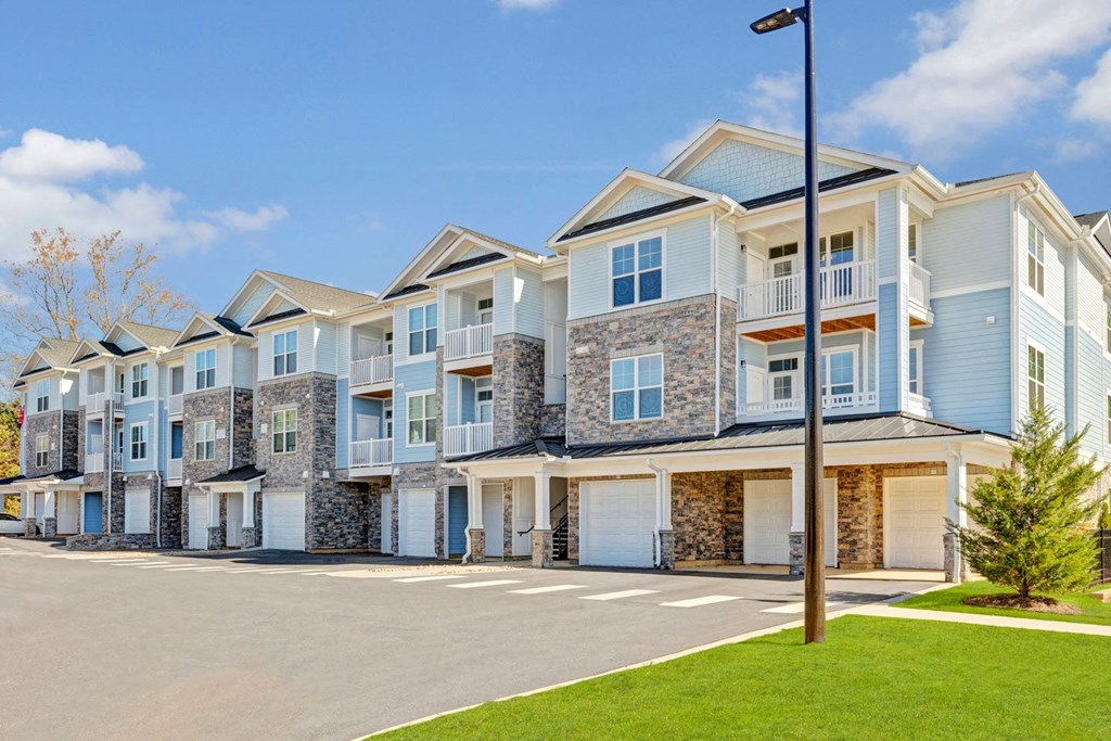 a row of town houses with a streetlight in front of them