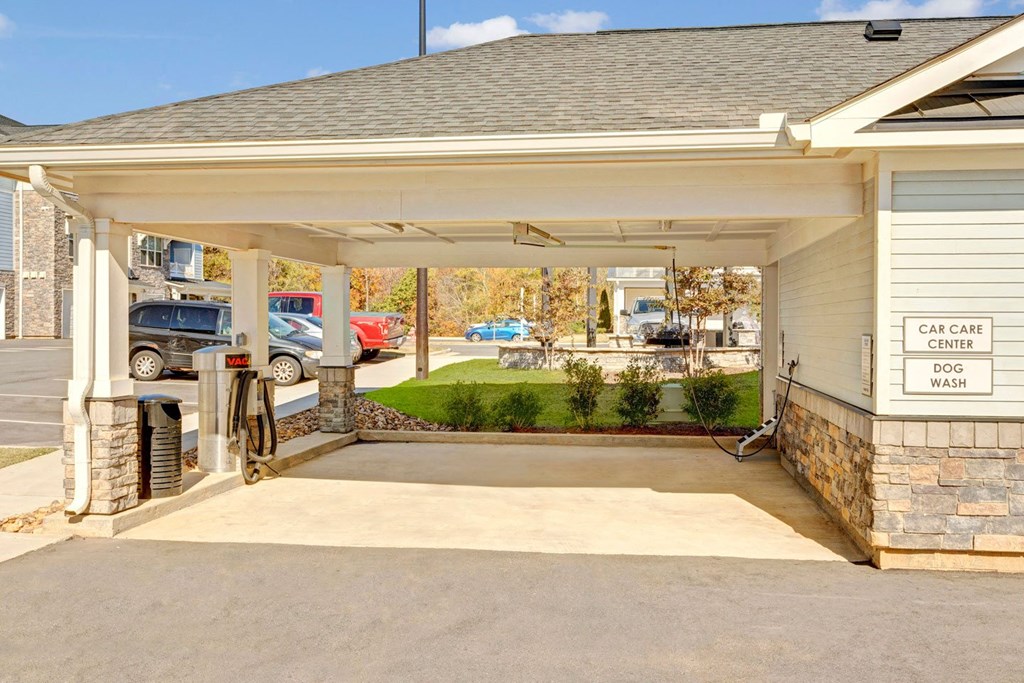 the entrance of a car garage with a driveway to a house