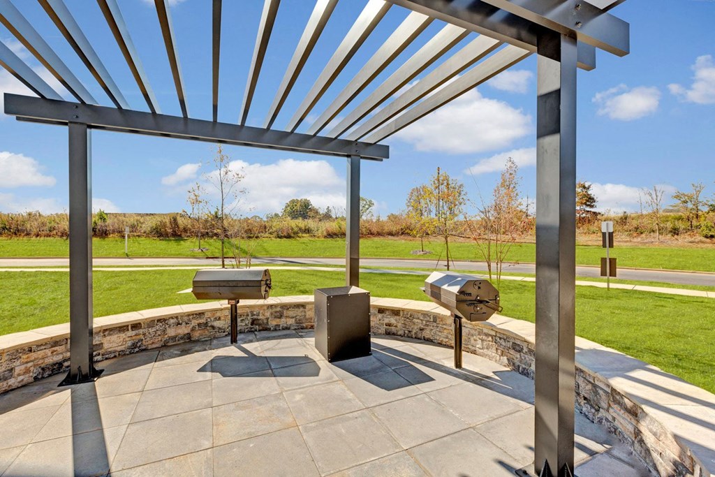 a patio with awnings and two hot tubs in a park