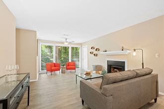 Living room, large window, wood-like flooring and ceiling fan
