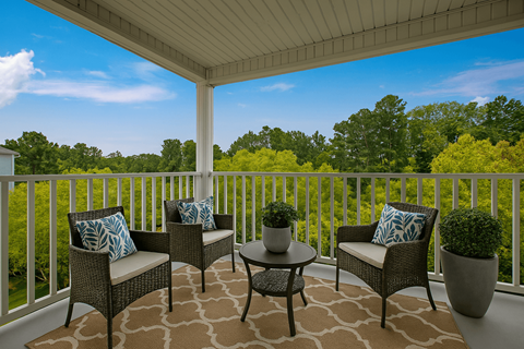 Private apartment patio with outdoor seating and wooded views at Canterbury Apartments in Myrtle Beach, SC