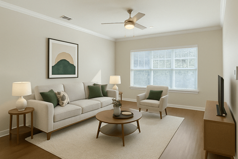 A living room with a white couch, a coffee table, and a painting on the wall.