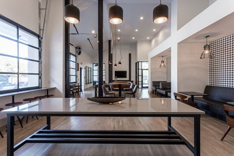 Resident conference room with table and workspace seating at Icon Avondale apartments in Decatur, GA