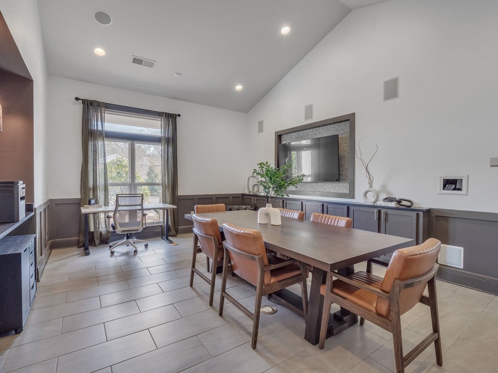a dining room with a wooden table and chairs