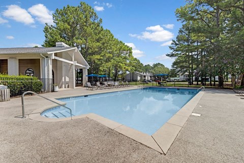 Resort-style swimming pool with sundeck and lounge area at Elements of Madison Apartments
