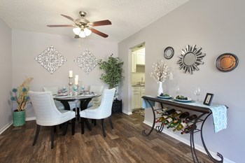 Classic dining room Classic living room with wood-like vinyl plank flooring and ceiling fan with warm walls. - Photo Gallery 6
