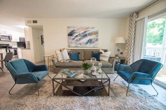 a living room with blue chairs and a couch