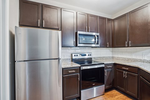 a kitchen with stainless steel appliances and granite counter tops