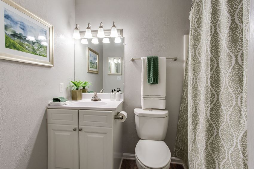 bathroom remodeled. white counters, white cabinets, tub, and large mirror. - Photo Gallery