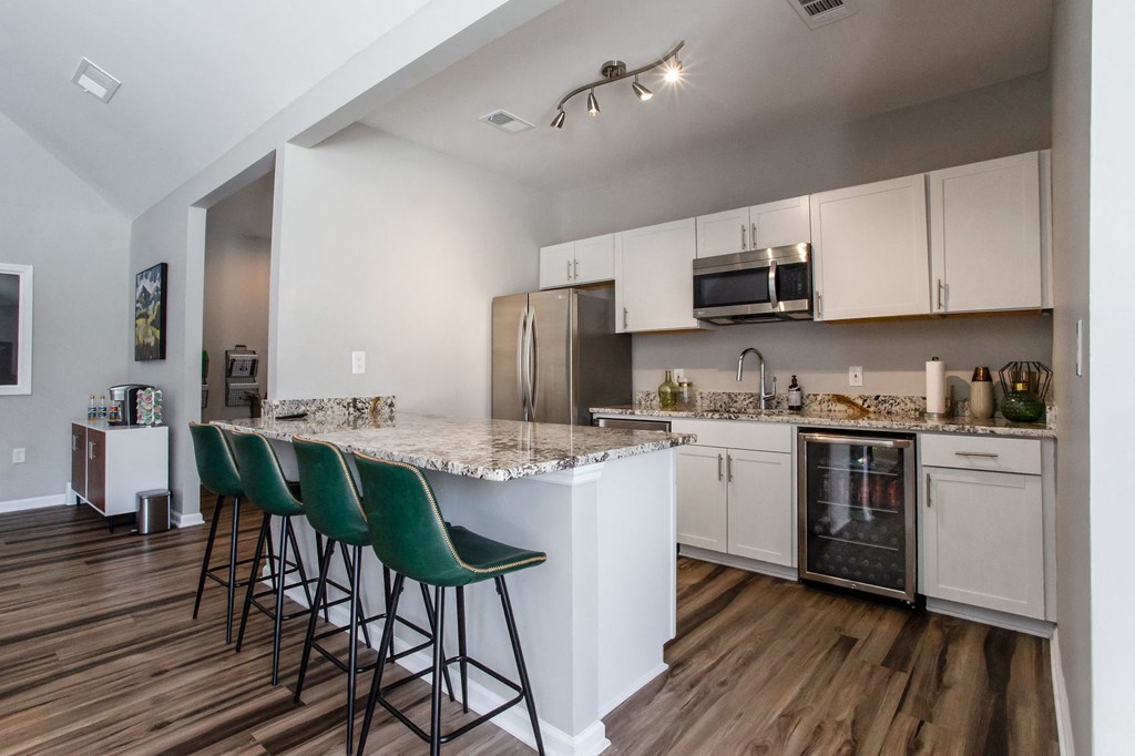 kitchen area of remodeled clubhouse. Granite countertops, seating at island, stainless steal appliances.