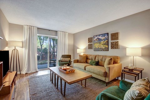 Living room, large couch, two sofa chairs, glass sliding door to patio