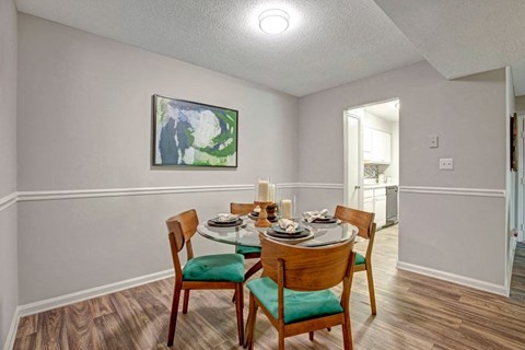 Apartment dining area with open living space at Pinewood at National Hills Apartments in Augusta, GA