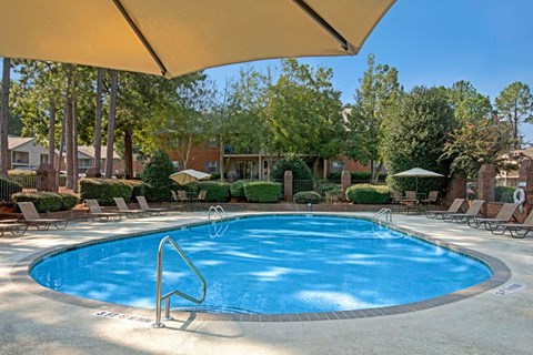 Resort-style swimming pool with sundeck and lounge seating at Pinewood at National Hills in Augusta, GA