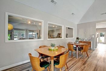 A dining room with a wooden table and chairs.