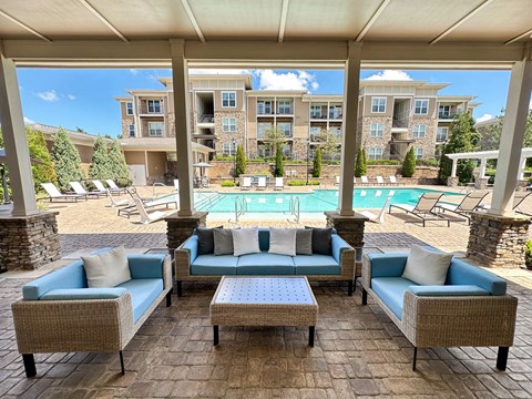 Resort-style swimming pool with sundeck and lounge seating at Promenade at Pinnacle Hills in Rogers, AR