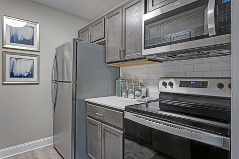 a kitchen with a stove top oven next to a refrigerator