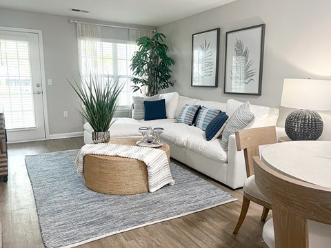 a living room with a white couch and a round table