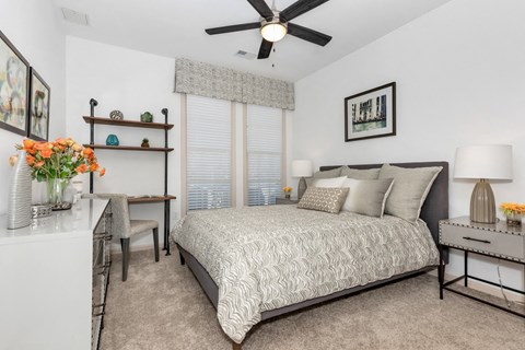 Comfortable apartment bedroom with natural light and modern finishes in Huntsville, AL