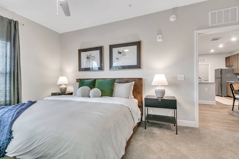 Modern apartment bedroom with a spacious layout and adjoining kitchen at The View on Canton apartments in Cartersville, GA