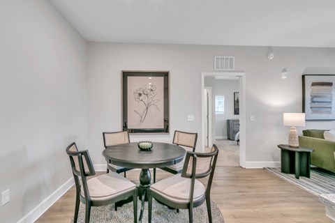 Apartment dining area with four-person table and open-concept living space at The View on Canton in Cartersville, GA