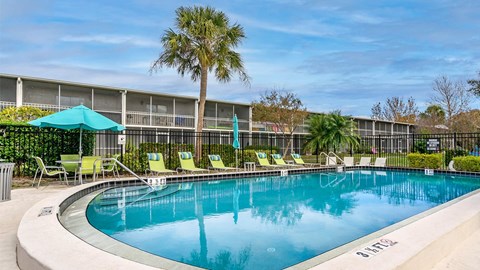 Swimming pool with lounge seating at Waterchase Apartments in Largo FL