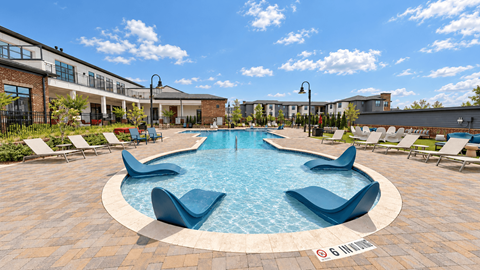 Shallow pool sun shelf with four blue in-water loungers at Argento at the Bridges in McDonough, GA.
