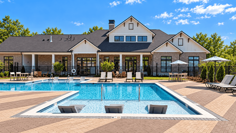 A large house with a pool in front.