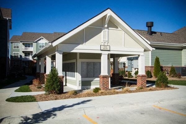 a small white house with a driveway in front of it