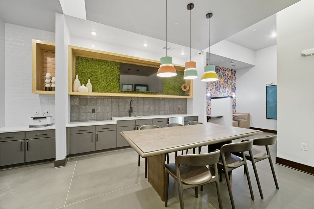A modern kitchen with a wooden table and chairs.