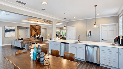 Clubhouse with a dining table, kitchen counter, coffee station, and lounge seating at Elevation 3505 in Atlanta, GA.