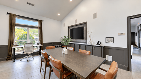 A dining room with a wooden table and chairs.