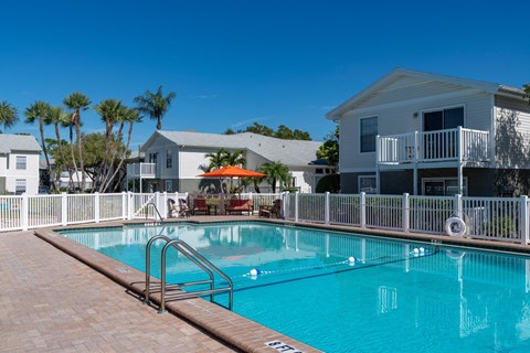 Resort-style swimming pool with sundeck and lounge area at Mystic Bay Apartment Homes in Largo, FL