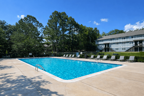 Resort-style swimming pool with sundeck and lounge seating at Madison Park Apartments in Birmingham, AL